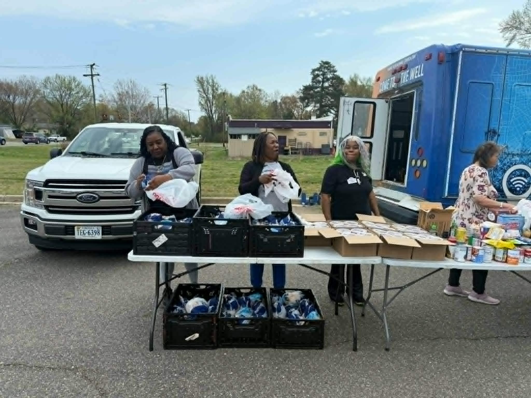 Earthly Angels volunteers distributing food and supplies to families in need